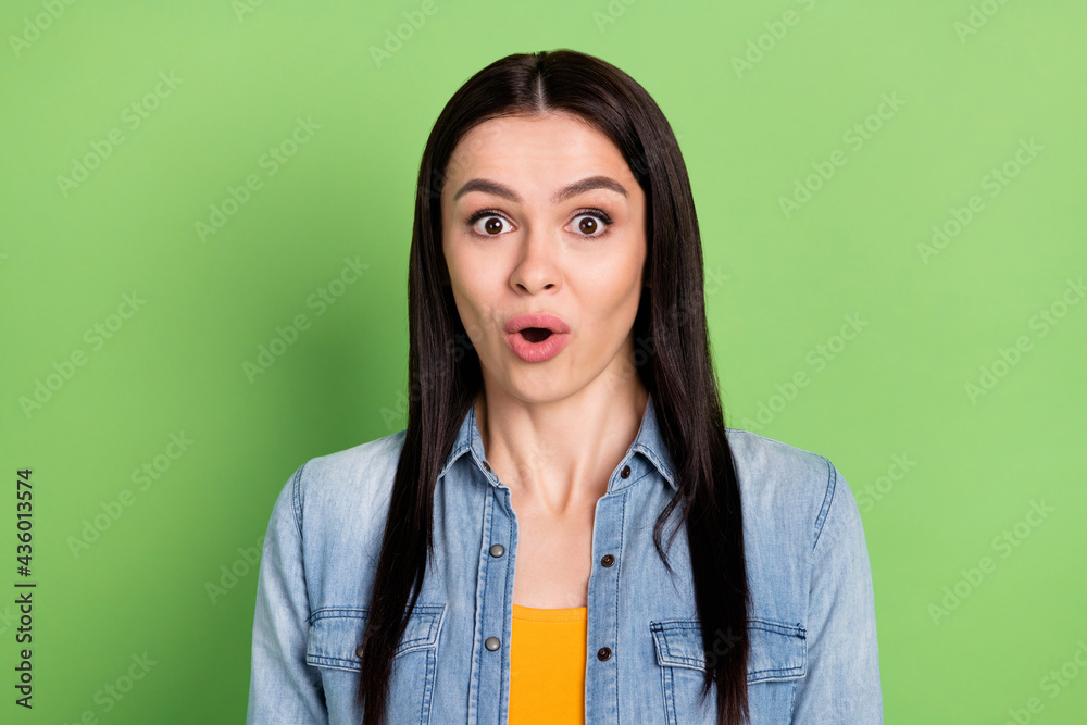 Photo of young shocked amazed surprised girl see huge sale discount unbelievable isolated on green color background Photo of young shocked amazed surprised girl see huge sale discount unbelievable isolated on green color background
