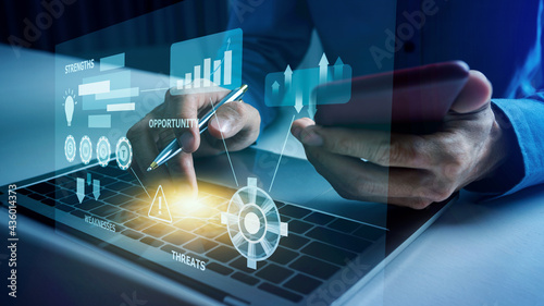 Business man works with SWOT virtual diagram, strengths, weaknesses, threats and opportunities text icon.