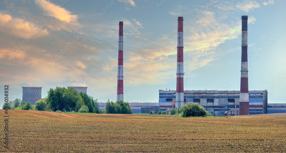 thermal power plant against the background of the sunset sky