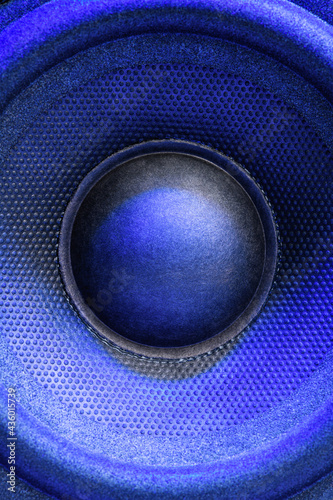 Audio speaker or music column with blue backlight, close up. Vertical photo