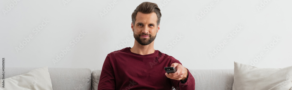 positive man clicking channels while watching tv at home, banner positive man clicking channels while watching tv at home, banner