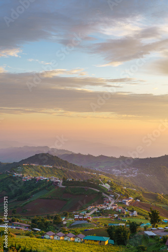 Beautiful landscape of Phu tub berk. agriculture village on the mountain with layer mountain and cloudy with sunset background.
