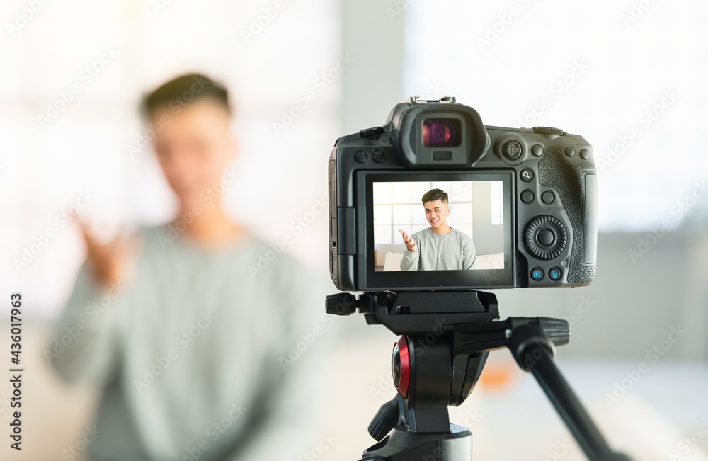 Young man recording video for an internet reportage or tutorial streaming