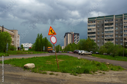 Fotografija Road closed for repair work on outskirts of city and storm clouds above it