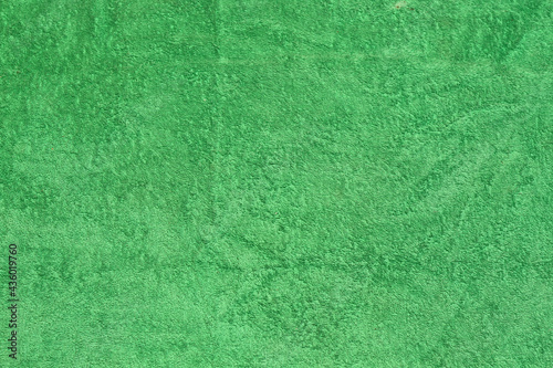 Green beach towel. Part of a terry towel.Background.