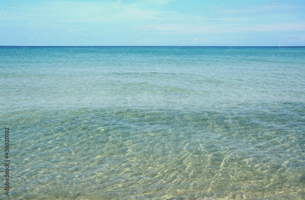 The crystalline waters of the Mediterranean sea in Sicily with intense turquoise and yellows reflections for a healthy bath in the aromas of saltiness.