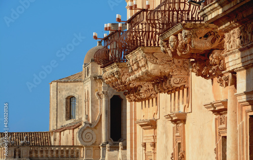 Palazzo Nicolaci is one of the main examples of Sicilian Baroque. The balconies with curved iron railings, corbels in carved stone with grotesque figures. photo