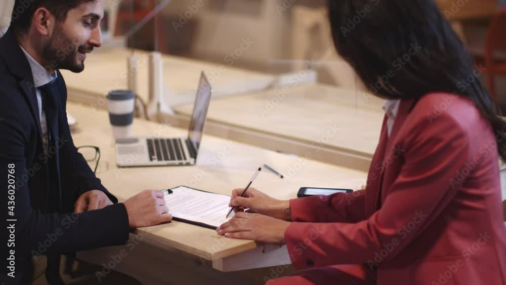 Businessman showing client in office where to sign contract