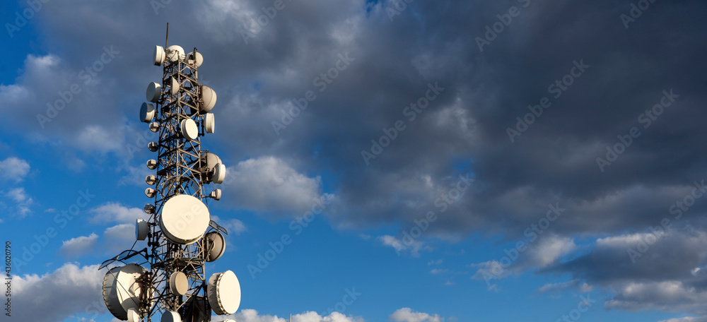 a cloudy sky and a telecommunications pole