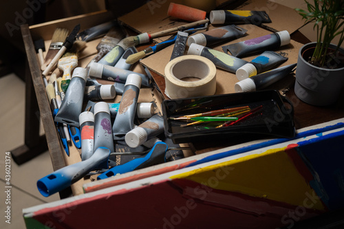 Drawer,cabinet of the artist, painter with scattered, disordered paints in a tube, paint brushes, artistic mess in the paint store, in the studio.