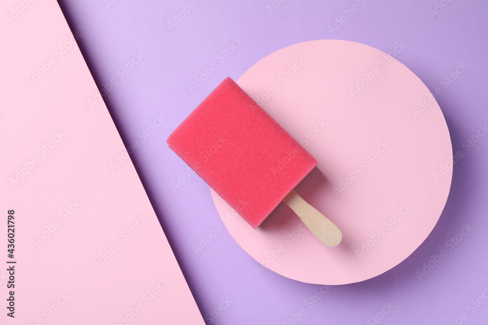 Sponge with wooden stick as ice cream on color background, top view. April Fools' Day Sponge with wooden stick as ice cream on color background, top view. April Fools' Day