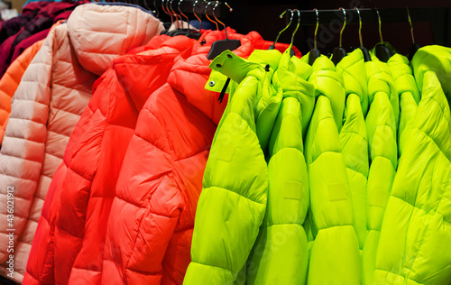 Photo of fashion store rack with various colored winter jackets.