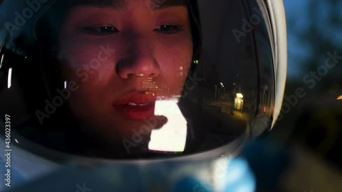 Close-up of Asian astronaut looking at digital device