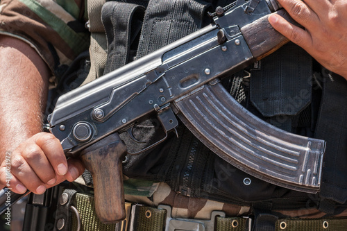 Detail view of a AKM or AK47 at the hands of a peruvian soldier photo