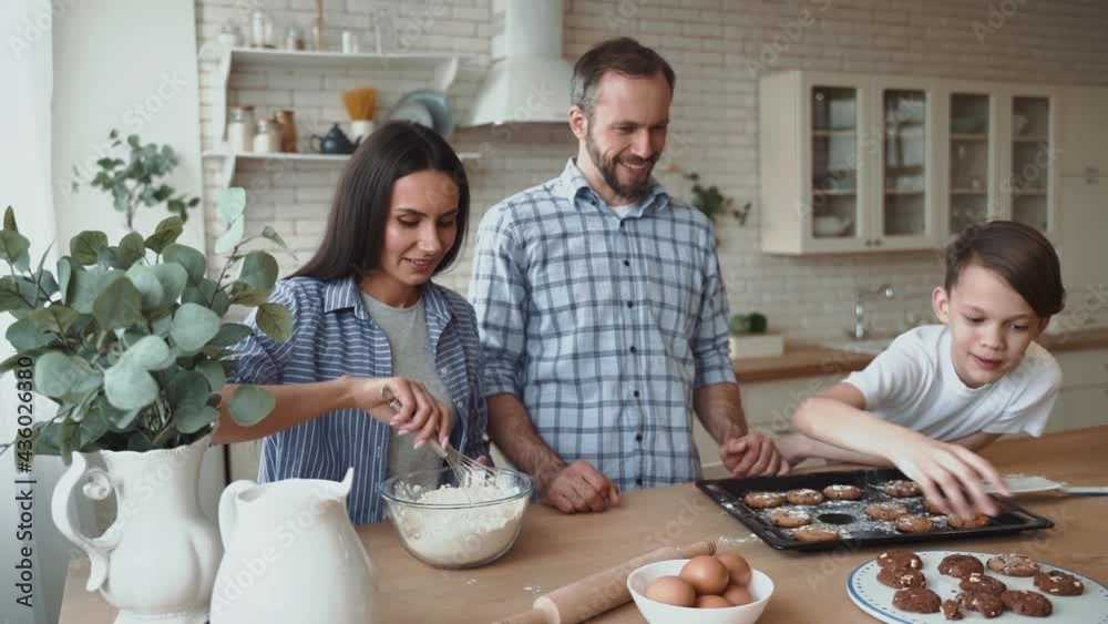 Familiy preparing cookies together in kitchen Familiy preparing cookies together in kitchen