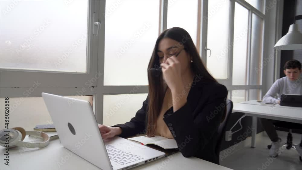 Young entrepreneur working on laptop in coworking space Young entrepreneur working on laptop in coworking space