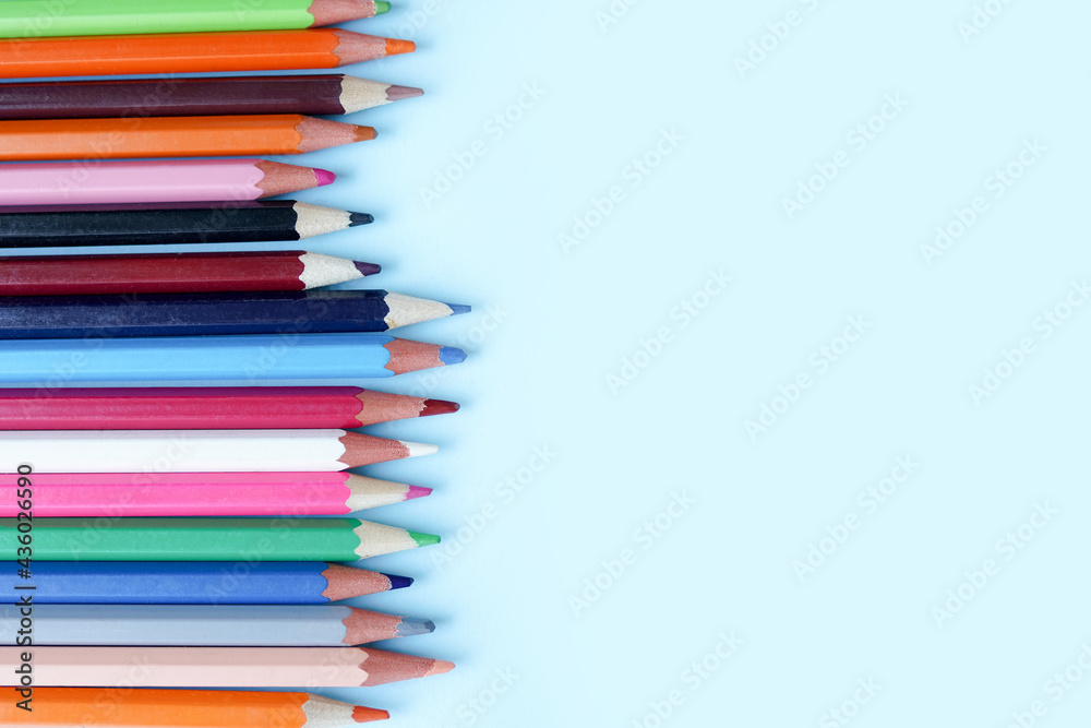 Colour pencils on blue background with copy space Colour pencils on blue background with copy space
