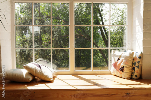 Fotografía Modern window with pillows, trees and sky behind