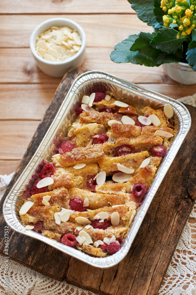 Bread pudding with raspberry. Side view, wooden background. Bread pudding with raspberry. Side view, wooden background.