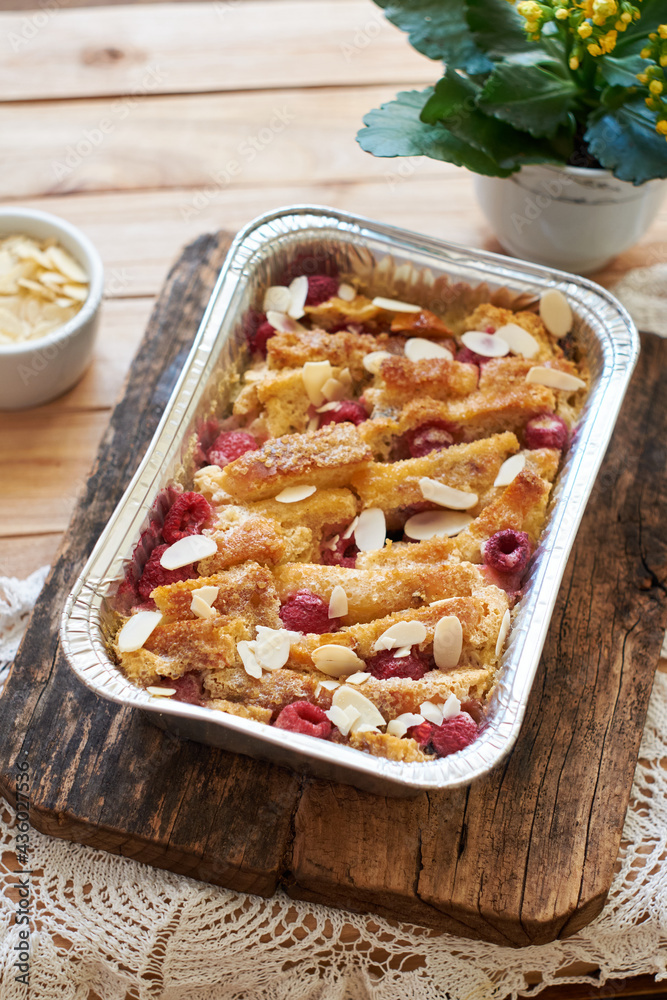 Bread pudding with raspberry. Side view, wooden background. Bread pudding with raspberry. Side view, wooden background.