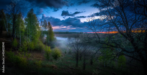 Evening fog, after sunset, rises from the ground and gradually fills the ravine with white clouds of steam