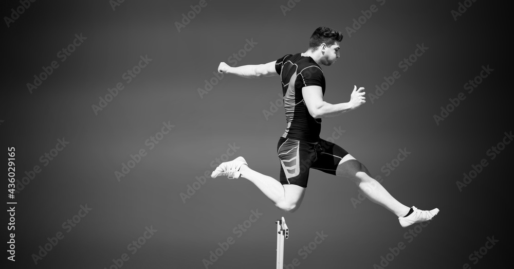 Composition of male hurdle jumper with copy space in black and white Composition of male hurdle jumper with copy space in black and white