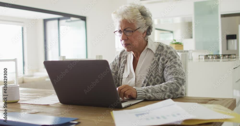 Thoughtful african american senior woman using laptop at home Thoughtful african american senior woman using laptop at home