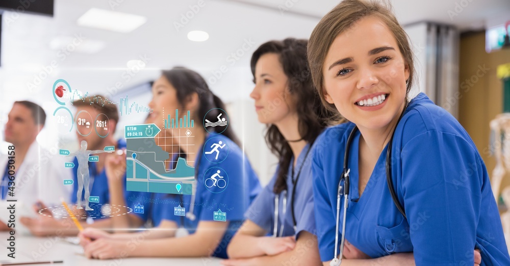 Composition of smiling team of doctors at meeting and medical research data interface screen Composition of smiling team of doctors at meeting and medical research data interface screen