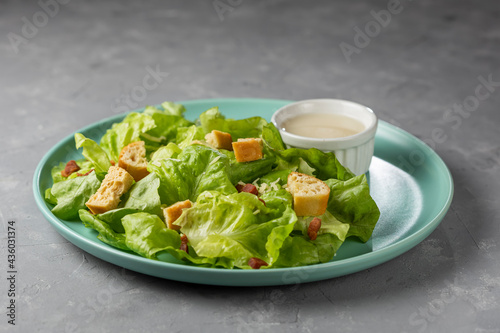 Caesar salad with croutons and bacon.