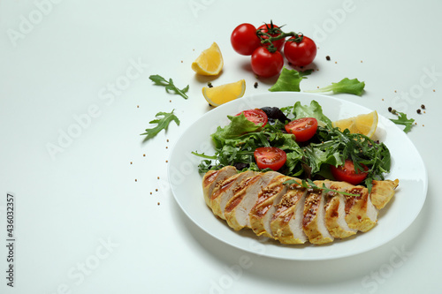 Concept of tasty eating with salad with grilled chicken on white background