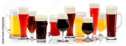 Set of fresh different beer glasses with bubble froth on white background.
