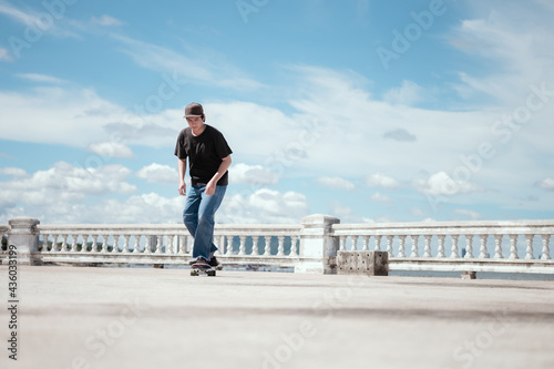 Cool teenage skateboarding in urban park as a hobby