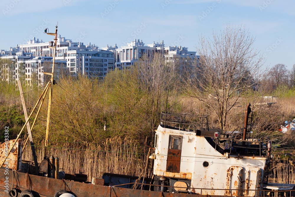 Old ship on the background of buildings of the modern city Old ship on the background of buildings of the modern city