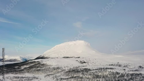 Aerial drone view towards the Saanatunturi fell, sunny day, in Lapland, Finland photo