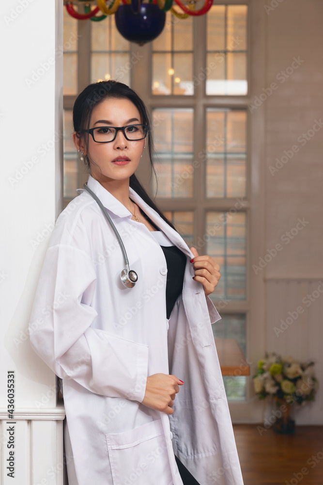 Portrait of female doctor with a stethoscope in white uniform standing in a hospital. Portrait of female doctor with a stethoscope in white uniform standing in a hospital.