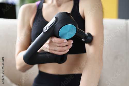 Young woman doing massage relaxing massage for hands in vibrating massager photo