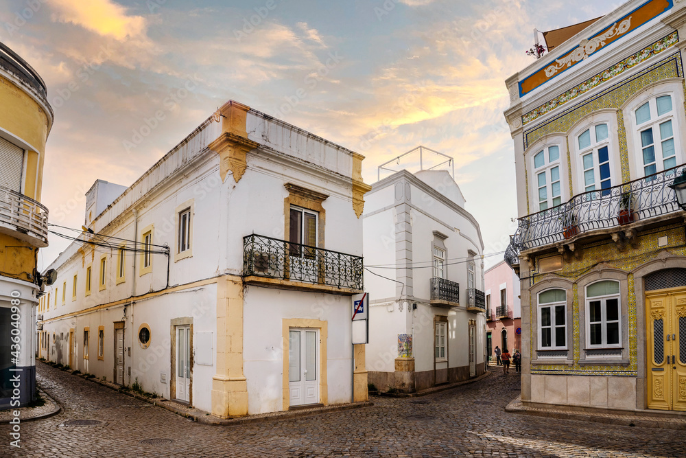 Narrow street with traditional fishermen's houses in Olhao, Portugal