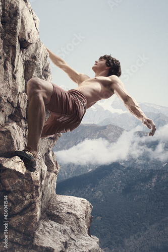 Young Caucasian man, male rock climber practicing in mountains over cloudy sky background. Collage, artwork