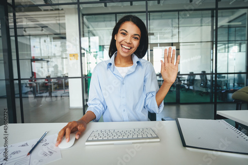 Beautiful young lady greeting someone on video-call