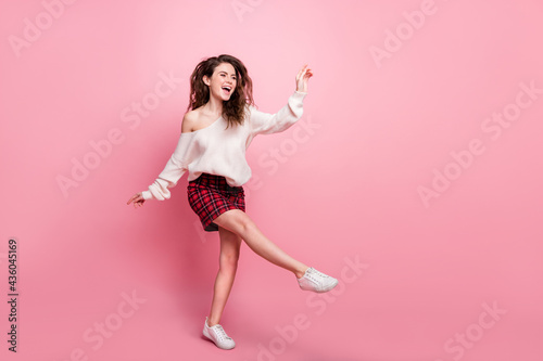 Full body profile side photo of young attractive girl happy positive smile have fun isolated over pink color background