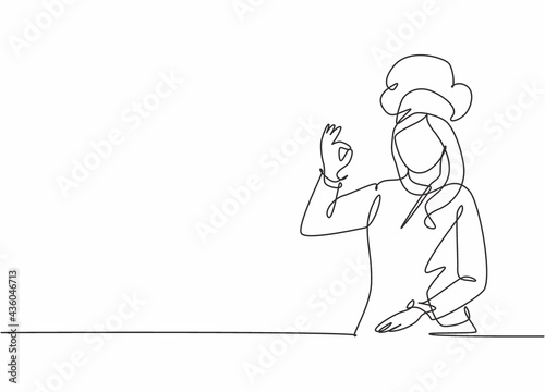 Single continuous line drawing of young excited beauty attractive female chef pose standing and giving okay gesture. Restaurant banner concept one line drawing design vector graphic illustration