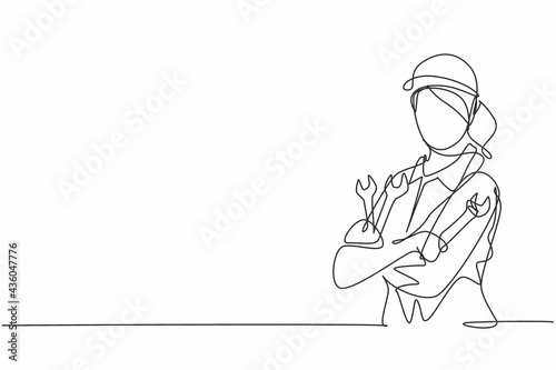 Continuous one line drawing of young female mechanic pose cross arms while holding set of wrench. Professional job profession minimalist concept. Single line draw design vector graphic illustration