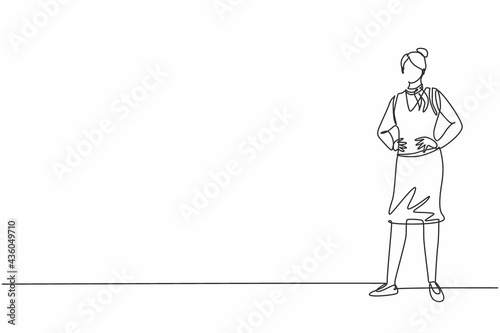 Single one line drawing young female stewardess standing posing with hands on hip. Professional work profession and occupation minimal concept. Continuous line draw design graphic vector illustration