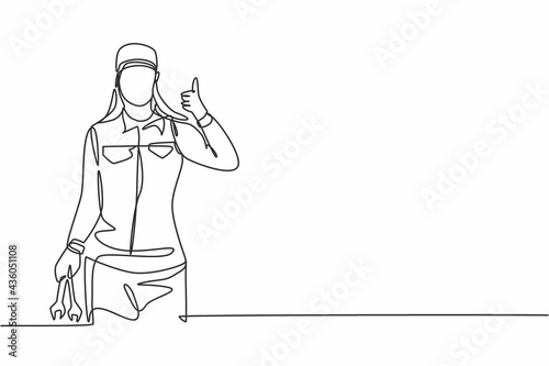 Single one line drawing of female mechanic with a thumbs-up gesture and holding the wrench works to fix a broken car engine in garage. Modern continuous line draw design graphic vector illustration