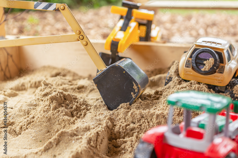 close-up of children toys in a sandbox in a garden outdoors