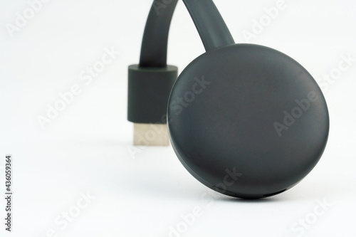 Chromecast media streaming player device on white background. Selective focus. photo