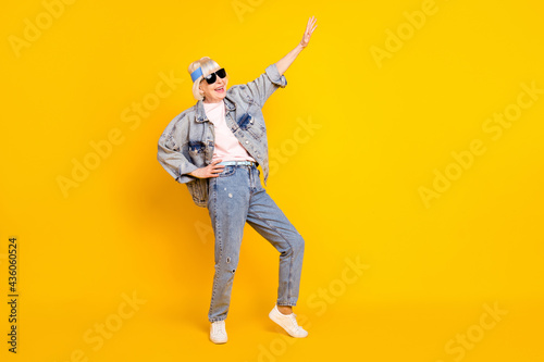 Full length body size view of attractive glad cheerful woman having fun weekend isolated over bright yellow color background