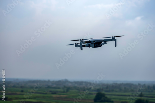 Close up shot of a quadracopter drone hovering near the camera at Pune India.
