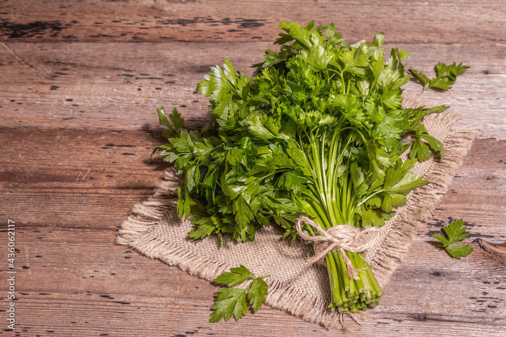 Fresh parsley as a cooking concept on an old wooden table Fresh parsley as a cooking concept on an old wooden table