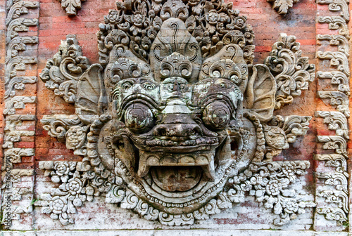 Ubud, Bali, Indonesia. Traditional Indonesian totem of a sacred creature on the wall of the ancient Ubud palace puri saren agung.